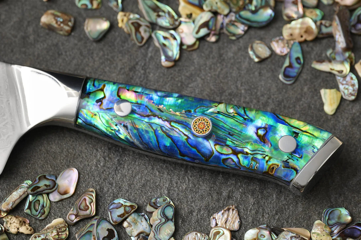 Kitchen knife with a decorative abalone handle on a white background