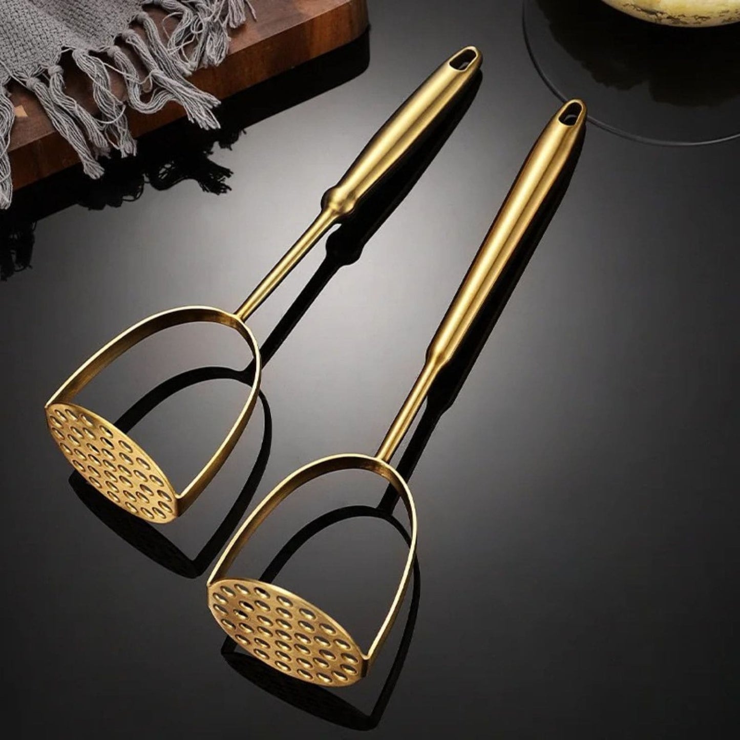 Ergonomic kitchen tool for mashing potatoes and soft vegetables