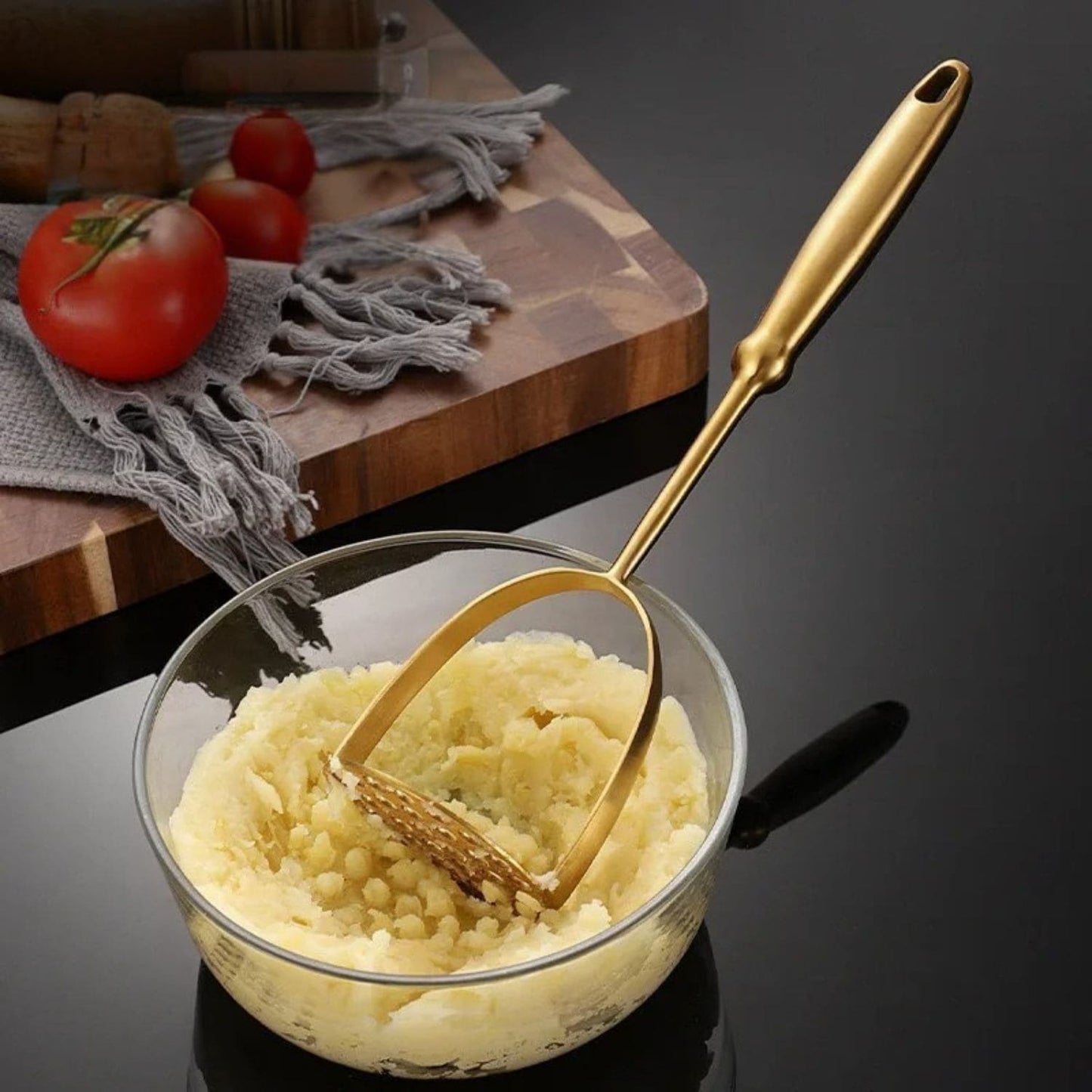 Ergonomic kitchen tool for mashing potatoes and soft vegetables