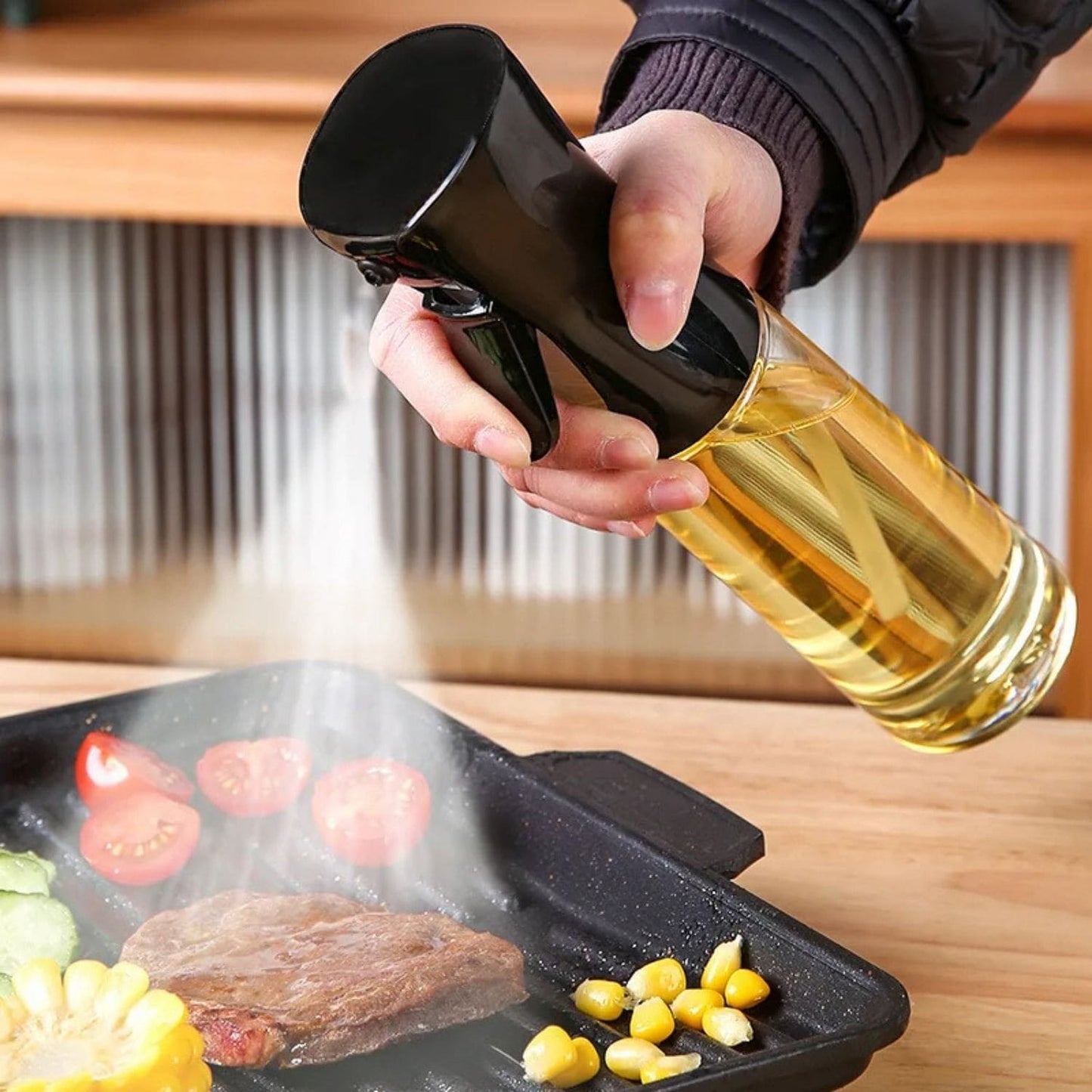 Transparent oil spray bottle with ergonomic trigger and modern design