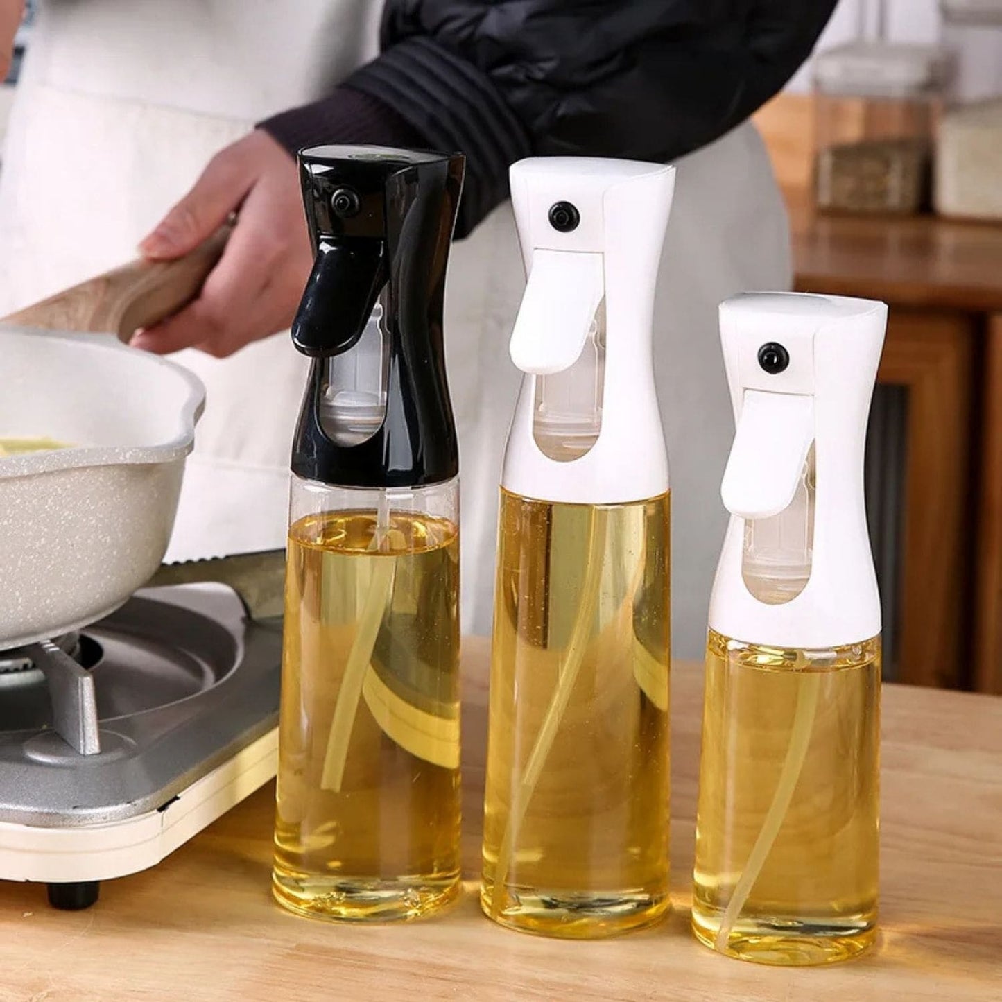 Transparent oil spray bottle with ergonomic trigger and modern design