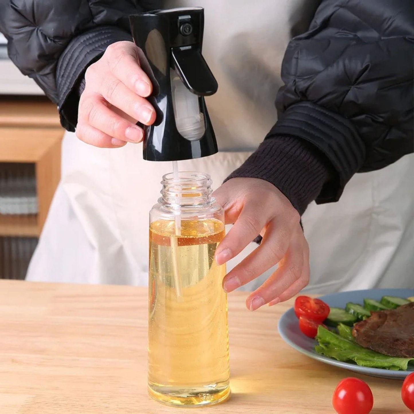 Transparent oil spray bottle with ergonomic trigger and modern design