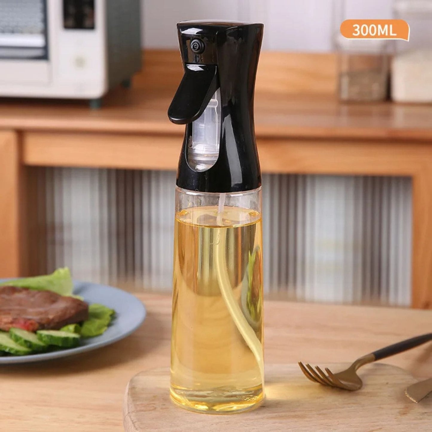 Transparent oil spray bottle with ergonomic trigger and modern design