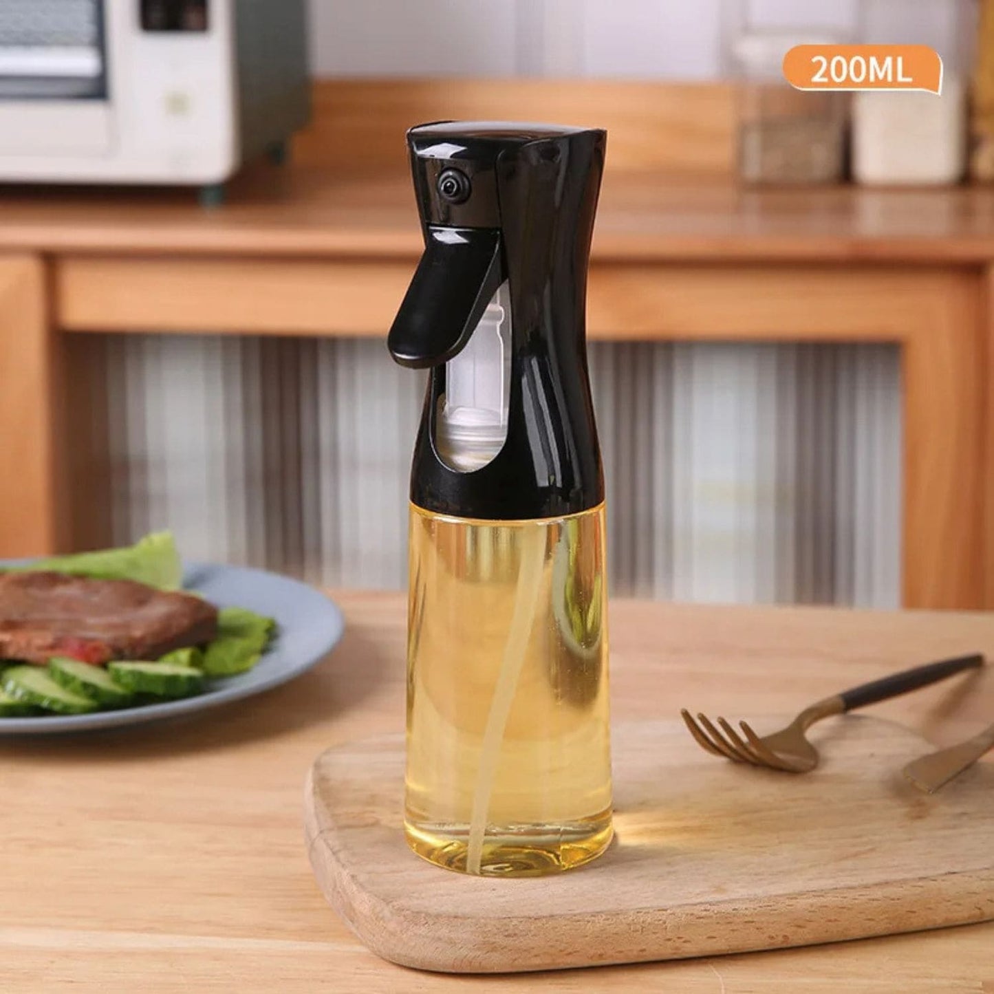 Transparent oil spray bottle with ergonomic trigger and modern design