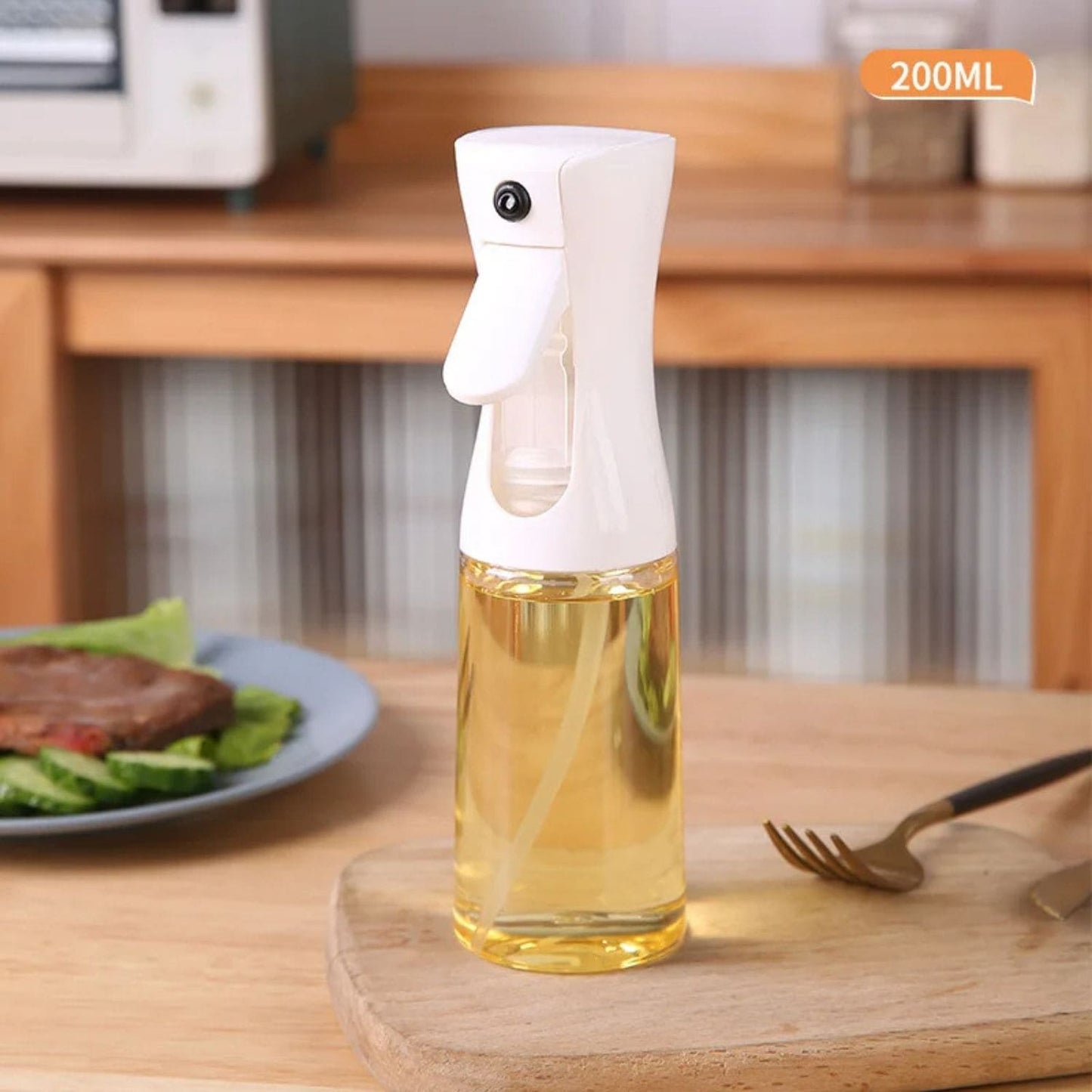 Transparent oil spray bottle with ergonomic trigger and modern design