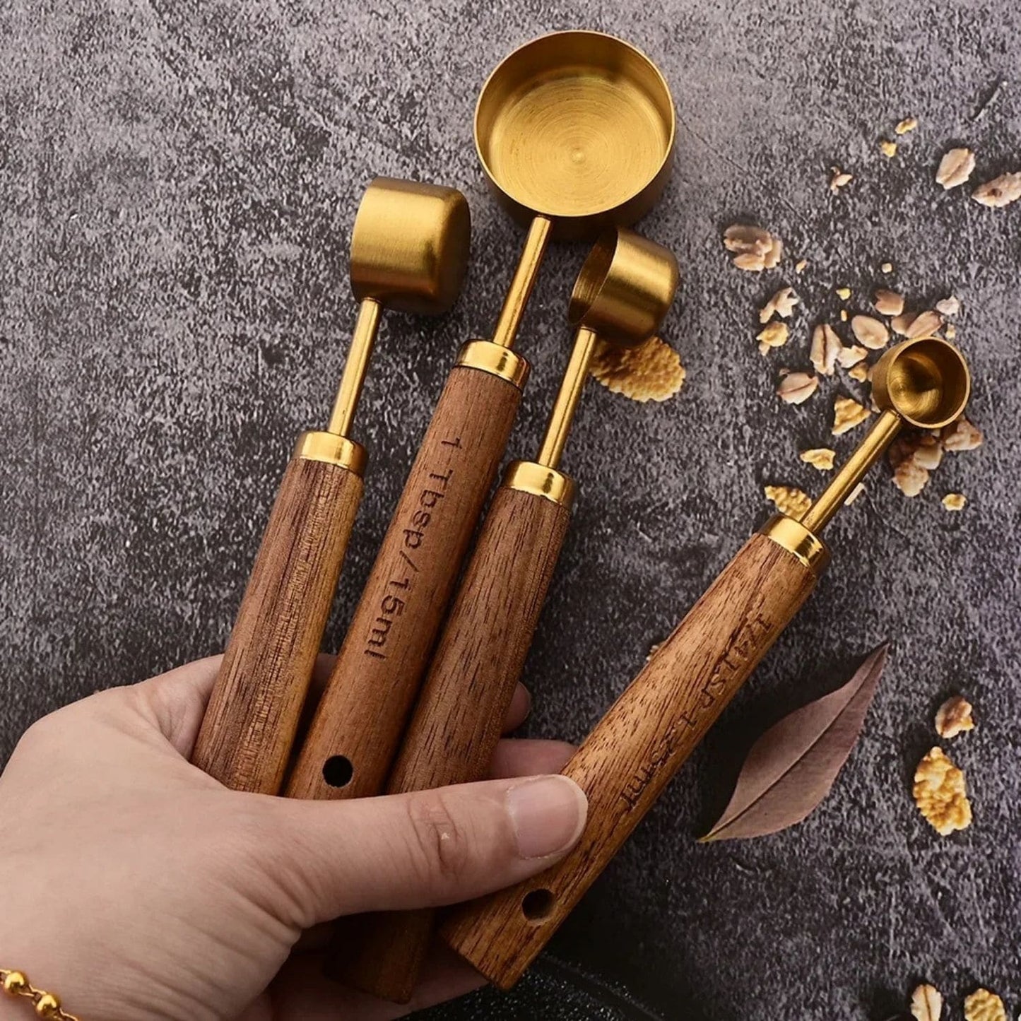 Gold measuring cup and spoon set with wood handles for precise baking