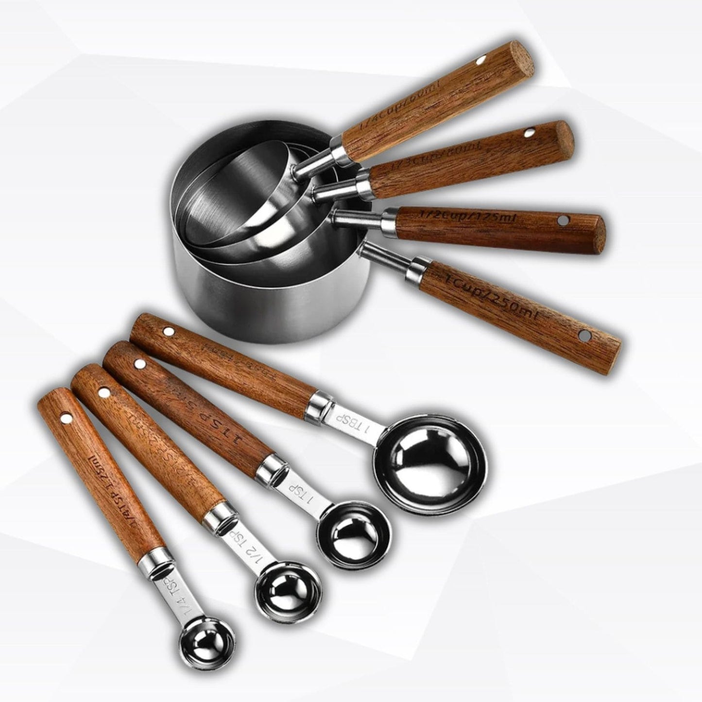 Silver measuring spoons and cups with wooden grips, displayed with flour and sugar
