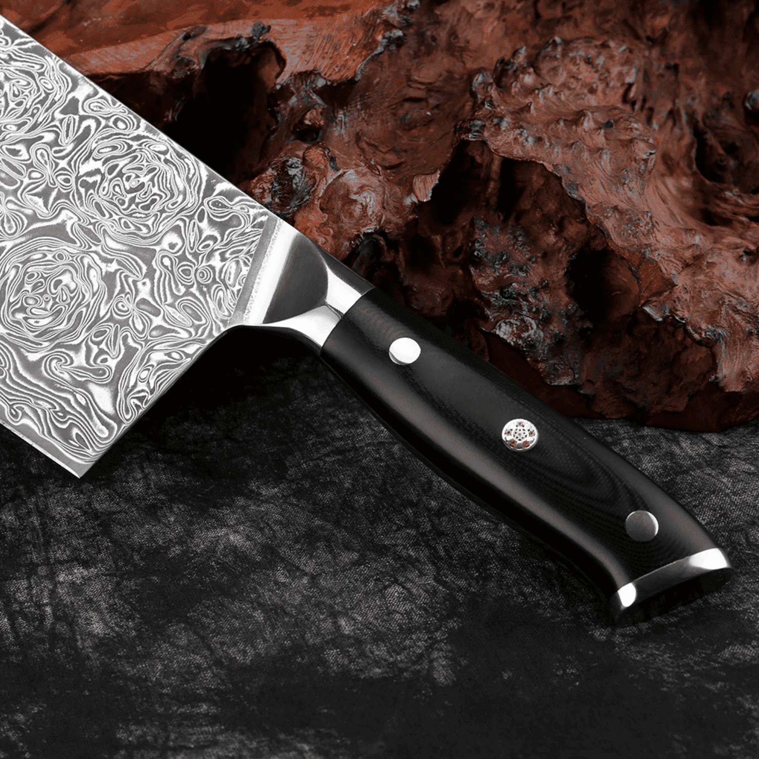 Decorative chef's knife with a black handle on a dark surface