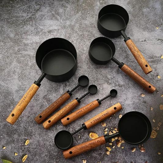 Modern kitchen setup with wooden-handle measuring set in black finish