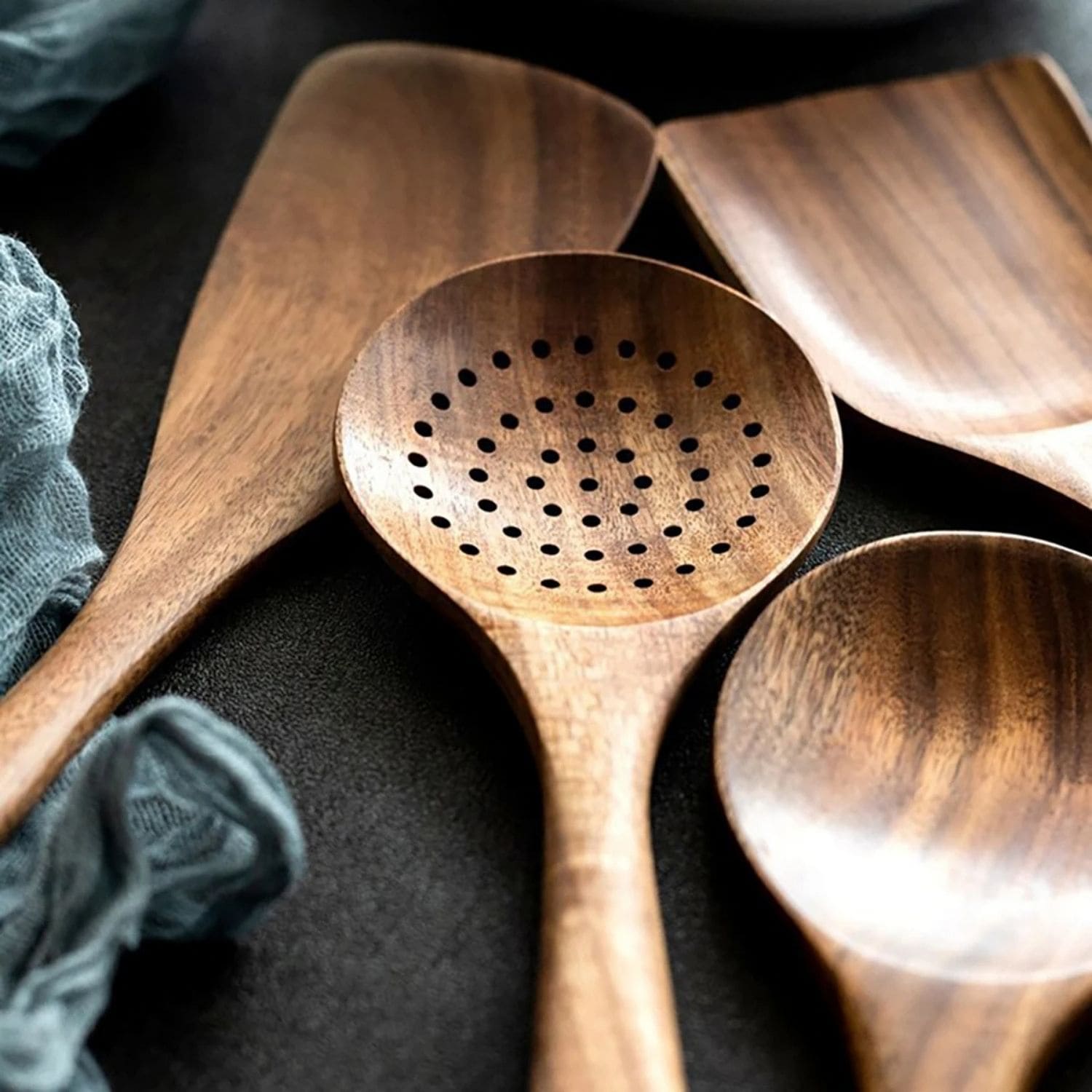 Eco-friendly wood utensil set displayed on a modern kitchen countertop