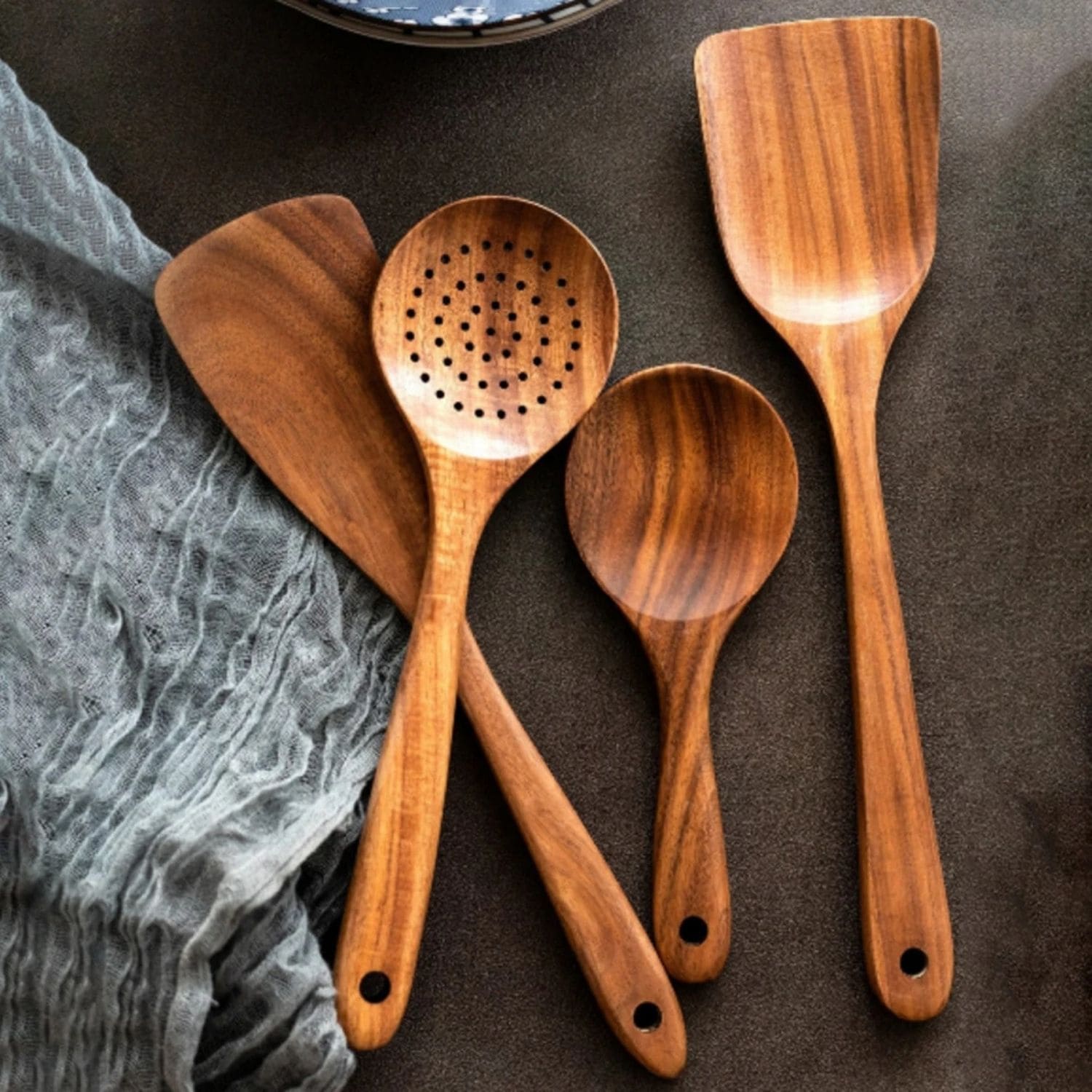 Eco-friendly wood utensil set displayed on a modern kitchen countertop